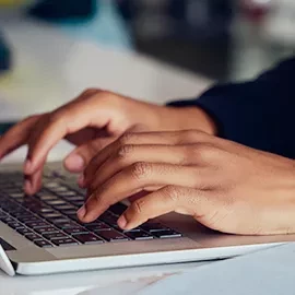 Person typing on keyboard